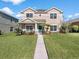 Charming home with a neatly manicured lawn and verdant landscaping at 1030 Bending Oak Trl, Winter Garden, FL 34787