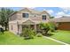 Two-story home with lush landscaping and a well-maintained lawn at 1030 Bending Oak Trl, Winter Garden, FL 34787