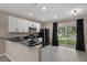 Stylish eat-in kitchen with stainless appliances, granite counters, and slider access to the outdoors at 1030 Bending Oak Trl, Winter Garden, FL 34787