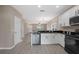 Kitchen features stainless appliances, granite counters, and open layout at 1030 Bending Oak Trl, Winter Garden, FL 34787