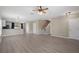 Spacious living area with sleek floors, access to stairs, and an open floorplan at 1030 Bending Oak Trl, Winter Garden, FL 34787