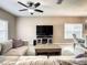 Cozy living room with neutral tones, a comfortable sofa, and a ceiling fan at 1030 Bending Oak Trl, Winter Garden, FL 34787