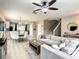 Inviting living room adjacent to the dining area and kitchen with bright, neutral decor at 1030 Bending Oak Trl, Winter Garden, FL 34787