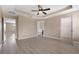 Spacious main bedroom with tray ceiling, wood-look floors, and neutral paint at 1030 Bending Oak Trl, Winter Garden, FL 34787