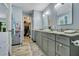 Modern bathroom featuring double sinks, gray cabinets, granite countertop, and a walk-in closet at 104 Autumn Dr, Longwood, FL 32779