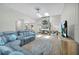 Bright, open-concept room features a stunning stone fireplace and a large blue couch at 104 Autumn Dr, Longwood, FL 32779