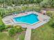 Community pool surrounded by lush landscaping, fencing, and lounge furniture, offering a serene and private outdoor space at 104 Autumn Dr, Longwood, FL 32779