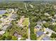 Aerial view of a suburban neighborhood with mature trees, manicured lawns, and homes with backyard pools at 1121 Northern Way, Winter Springs, FL 32708