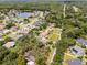 Scenic aerial view of a residential area near a pond, showcasing the well-kept lawns and tree-lined streets at 1121 Northern Way, Winter Springs, FL 32708