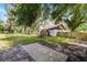 Picturesque backyard featuring mature trees, lush lawn, and a newly installed wooden fence at 1121 Northern Way, Winter Springs, FL 32708