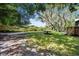 Spacious backyard showcasing a well-maintained lawn, mature trees, and a wooden fence at 1121 Northern Way, Winter Springs, FL 32708