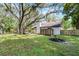 Tranquil backyard boasting mature trees, a green lawn, and a charming wooden fence for added privacy at 1121 Northern Way, Winter Springs, FL 32708