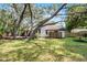 Secluded backyard featuring mature trees and a green lawn, perfect for outdoor enjoyment at 1121 Northern Way, Winter Springs, FL 32708