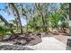 Tranquil backyard offers a serene retreat with lush greenery and tiled patio space at 1121 Northern Way, Winter Springs, FL 32708