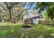 Expansive backyard with mature trees, a well-manicured lawn, and a freshly stained wooden fence at 1121 Northern Way, Winter Springs, FL 32708