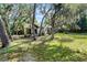Lush backyard with mature trees providing shade and privacy for this charming home at 1121 Northern Way, Winter Springs, FL 32708