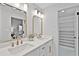 Bright bathroom featuring double sinks, white cabinets and generous storage at 1121 Northern Way, Winter Springs, FL 32708