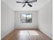 Bedroom with wood floors, ceiling fan, and a large window allowing plenty of natural light at 1121 Northern Way, Winter Springs, FL 32708
