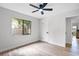 Bright bedroom features wood floors, neutral walls, ceiling fan, and a large window with natural light at 1121 Northern Way, Winter Springs, FL 32708