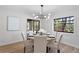 Bright dining room with a round table, modern lighting, and a window offering a pleasant view at 1121 Northern Way, Winter Springs, FL 32708