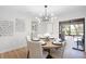 Dining area with a modern chandelier and access to a screened in lanai at 1121 Northern Way, Winter Springs, FL 32708