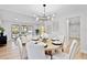 Open-concept dining area with a stylish chandelier, seamlessly flowing into the living space at 1121 Northern Way, Winter Springs, FL 32708