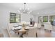 Open-concept dining area with a stylish chandelier, seamlessly flowing into the living space at 1121 Northern Way, Winter Springs, FL 32708