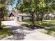 Charming single-story home featuring a spacious driveway and meticulously landscaped front yard with mature trees at 1121 Northern Way, Winter Springs, FL 32708