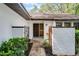 Welcoming front entrance with decorative gate and lush greenery, creating a charming curb appeal at 1121 Northern Way, Winter Springs, FL 32708