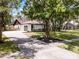 Charming single-story home with a long driveway, green lawn, and mature trees in a peaceful setting at 1121 Northern Way, Winter Springs, FL 32708