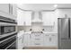 Stylish kitchen featuring stainless steel appliances, white cabinets, and an electric cooktop at 1121 Northern Way, Winter Springs, FL 32708