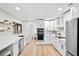 Modern, all-white kitchen featuring stainless steel appliances, quartz countertops and open shelving at 1121 Northern Way, Winter Springs, FL 32708