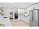 Bright kitchen featuring stainless steel appliances, white cabinetry, and a view into the dining area at 1121 Northern Way, Winter Springs, FL 32708