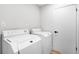 Functional laundry room features a washer, dryer, and white door to another room at 1121 Northern Way, Winter Springs, FL 32708