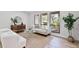 Bright living room featuring large windows, modern furniture, and beautiful wood-look flooring at 1121 Northern Way, Winter Springs, FL 32708