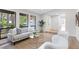 Bright living room featuring large windows, modern furniture, and beautiful wood-look flooring at 1121 Northern Way, Winter Springs, FL 32708