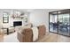 Bright living room boasts a white brick fireplace and sliding glass doors to an outdoor dining area at 1121 Northern Way, Winter Springs, FL 32708