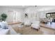 Bright living room featuring large windows, modern furniture, and beautiful wood-look flooring at 1121 Northern Way, Winter Springs, FL 32708