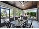 Screened-in patio features outdoor dining set, ceiling fan, and views of the landscaped backyard at 1121 Northern Way, Winter Springs, FL 32708