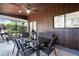 Screened-in patio features a dining set, fan, and views of the well-maintained backyard at 1121 Northern Way, Winter Springs, FL 32708