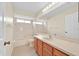The bathroom has tile flooring, white cabinets, a window, and a shower/tub combo at 14425 Huntingfield Dr, Orlando, FL 32824