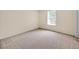 The bedroom has neutral walls, baseboards and carpet and a window with blinds at 14425 Huntingfield Dr, Orlando, FL 32824