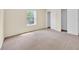 The bedroom features neutral walls, baseboards, carpet, a window, and a closet at 14425 Huntingfield Dr, Orlando, FL 32824