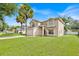Expansive lawn and two-story home with a two car garage provides ample space at 14425 Huntingfield Dr, Orlando, FL 32824