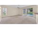 Neutral toned living area with sliders leading to a pool area at 14425 Huntingfield Dr, Orlando, FL 32824
