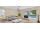 Bright living room featuring modern furniture and sliding glass doors to the pool at 14425 Huntingfield Dr, Orlando, FL 32824