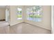 Bright living room featuring tile floors and large windows overlooking a private pool at 14425 Huntingfield Dr, Orlando, FL 32824