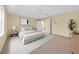 Relaxing bedroom with a neutral color palette, with a large bed, and stylish decor at 14425 Huntingfield Dr, Orlando, FL 32824