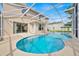The screened-in pool has a concrete deck and is surrounded by lush greenery at 14425 Huntingfield Dr, Orlando, FL 32824
