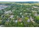 Overhead view of a home surrounded by lush trees, offering a quiet neighborhood setting and convenient access to facilities at 1503 Granite State Ct, Mount Dora, FL 32757